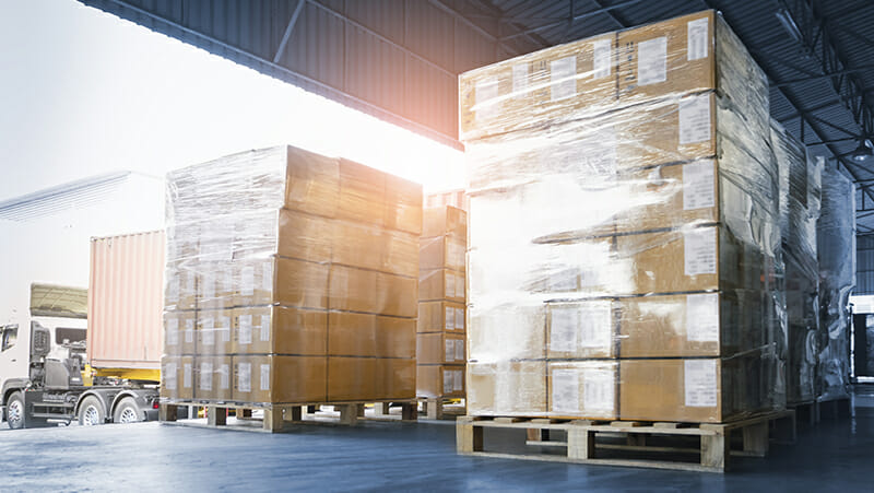 Stacked of Package Boxes Loading into Container Truck. Truck Parked Loading at Dock Warehouse. Delivery Service. Shipping Warehouse Logistics. Shipment Freight Truck Transportation.